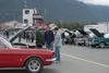 Car enthusiasts looks over the cars at the show at Alaska Raceway Park Saturday afternoon. J