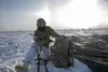 Sgt. Darnel Sawyer, a paratrooper with 3rd Battalion, 509th parachute infantry regiment, 4th Infantry Brigade Combat Team (Airborne), 25th Infantry Division, gathers his equipment after parac