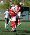 Colony's Cade Johnstone and Kenai's Braydon Goodman are among a group of players all going up for a header off a corner kick during Kenai's 3-1 win over the Knights in the Northern Lights Con