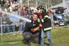 Palmer Fire Chief John McNutt helps Nathan Dunn shoot water from a real firehose. Jacob Mann/Frontiersman