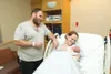 ROBERT DeBERRY/Frontiersman Donald Potteiger looks on as his
wife Jackie Garrick holds their new baby, Temperance Anastasia
Nycole Potteiger. Garrick gave birth Thursday morning in their van

