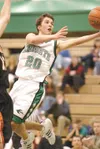 ROBERT DeBERRY/Frontiersman Colony junior guard Doug Gray floats
through the air toward the basket during the Knights’
season-opening loss to West Anchorage. The Knights have steadily
improve