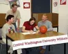 Kelly Quinn signs a letter of intention Monday in the Colony
High School library to play basketball at Central Washington
University. Quinn is flanked by her mother Pattie and father Dick.
Co