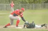 ROBERT DeBERRY/Frontiersman Colony’s Mike Wagner, right, slides
underneath the tag of Wasilla first baseman David Green during a
win over the Warriors.