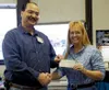Animal Care and Regulation Chief Officer Dave Allison accepts an
$810 check from Kathy Ayers, secretary of the Matanuska Agility
Canine Handlers at the borough Tuesday. Photo by RINDI
WHITE/F