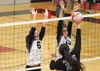 Colony's Shiann Bontrager and Eve Stephens reach up for the block as Palmer's Kennedy Bryan attacks during Colony's 3-0 victory over the Moose in the Northern Lights Conference Championships 