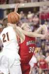 ROBERT DeBERRY/Frontiersman Wasilla Warrior Connor Devine draws
a foul as he drives to the basket for two points during the first
period of Wednesday’s 4A championship game against the West H