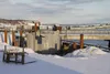 A contractor who has been working on the damaged barge dock at Port MacKenzie was set to resume work Thursday after the emergency approval of a $2.5 million loan from the borough's land manag