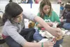 ROBERT DeBERRY/Frontiersman Girl Scout Troop 418 members Tiana
Stajic and Tori Clark learn canine first aid during a Girl Scouts
encampment at the Alaska State Fairgrounds last weekend.
