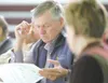 ROBERT DeBERRY/Frontiersman State Sen. Charlie Huggins looks
over an information packet provided by the King’s Ridge Owner
Association during Monday’s joint legislative Transportation
Committ