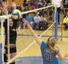 Palmer’s Elliot Perkins punches the ball over the net while Kodiak’s Megan Pyles goes up for the block during a Northern Lights Conference Volleyball Match Thursday in Kodiak. DEREK CLARKSTON