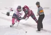 ROBERT DeBERRY’Frontiersman Dressed in a pink jersey for breast
cancer awareness, Alaska Avalanche forward Nardo Nagtzaam battles
for the puck against Fairbanks Ice Dog forward Paul Kirtland 