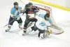 ROBERT DEBERRY/Frontiersman Alaska Avalanche goaltender Adam
Kraus reaches to grab the puck with his glove hand as Santa Fe
forward Joe Harren storms the Avalanche net during a loss to the
Ro