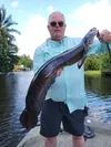 Andy Couch shows off snakehead, one of multiple exotic fish species he and his wife caught in the Lake Worth, Florida area this week. Courtesy of Andy Couch