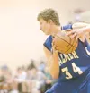 Palmer junior forward Bryce Jacobson protects the ball after
grabbing the rebound during the first round play against the Colony
knights during the First National/ASAA Alaska State Basketball