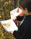 Angel Remaley, a Colony student, punches her map at an
orienteering control marker outside Colony High School Tuesday.
Photo by CASEY RESSLER/Frontiersman.