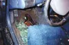 A lone shoe lies amid broken glass on the floor of 16-year-old
Julie Menerey's car after the Dec. 14, 2001, accident that resulted
in her death. Motor-vehicle crashes are the leading cause of