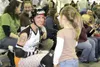 LANIER HUTCHESON/Frontiersman RageCity'€™s Killa Magilla takes
time during a halftime break to sign autographs for young fans.