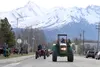 Arthur Keyes leads a parade of tractors through downtown Palmer Monday morning, part of the fourth annual Take Your Tractor to Work Day. Tim Rockey/Frontiersman