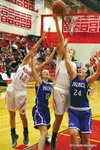 Wasilla junior Leya DePriest reaches high above Palmer’s Katy Bowman (15) and Alicia Smylie (24) for a rebound during a win over the Moose Tuesday at Wasilla High School. "MatSuSports.net"