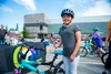 A winner of the Mat-Su Regional Medical Center bike drawing poses for a photo after receiving her prize. After winning, this attendee gave her old bike away to another participant who did not
