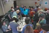 Dr. Gary Laursen, the director and president of the High Latitude Mycological Research Institute at the University of Alaska Fairbanks, examines a mushroom while his workshop class looks on S