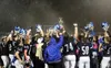 The Palmer Moose hoist the Mayor's Cup in the pouring rain after winning the 2019 Potato Bowl Friday night at Palmer High. Courtesy of Bruce Eggleston/matsusports.net