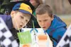 Brothers Owen Hoyt, 9, and Ethan Hoyt, 6, blow their homemade boats along the course in the Raingutter Regatta at the 2014 Bear Paw District Spring Camporee and Scout O Rama at the Matanuska 