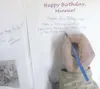 HEATHER A. RESZ/Frontiersman Colony ‘kid’ Earl Wineck, 84, signs
a birthday card Wednesday for Minnie Olson, the oldest Colonist
from the group that arrived in Palmer in May 1935. A Kentucky
