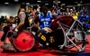 U.S. Air Force Senior Airman DeMarcus Garrett, Team Air Force athlete, powers through Team Navy defenders during the Department of Defense Warrior Games wheelchair rugby finals in Tampa, Fla.