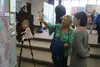 Local artist, Barbara Hunt admires Palmer High School junior, Emily Mack’s various works.