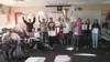 Peter Kamilos’ world history class celebrates taking an exam using braille. Sophomore Ginger Shepardson is visually impaired. The Wasilla High School class took a test using braille to develo