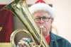 Jerry Kurtz holds a note during Colony Christmas tuba concert
Saturday at the Salvation Army in Palmer. (ROBERT
DeBERRY/Frontiersman)