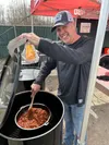 Palmer resident Tracey Hayes, head cook at Smokey Haze BBQ, stirs a pot of chili during Saturday’s sixth annual Breakup Shakeup barbecue competition. For the second year in a row, Hayes’ team