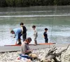 An angler helps a group of young fishermen during a youth-only fishing event at Eklutna Tailrace Aug. 20, 2016, near Palmer. Aaron Walling/Frontiersman