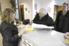 ROBERT DeBERRY/Frontiersman Wasilla City Clerk Kristie Smithers
prepares to receive a 284-signature petition seeking to recall city
councilman Steve Menard from Deanna Didrickson, center, and