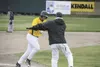 Mat-Su Miners assistant coach Joel Pedretti congratulates Miners designated hitter Chris Taladay as Taladay rounds third base after hitting a solo home run against the Chugiak Chinooks at Her