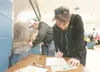 ROBERT DeBERRY/Frontiersman Valley resident Jeanette Clugston
fills out her ballot at Saturday’s annual Matanuska Electric
Association membership meeting at Palmer High School.