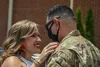 An airman greets his wife at Shaw Air Force Base, S.C., May 24, 2020, upon returning from a deployment to the U.S. Central Command area of responsibility.