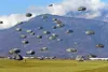 U.S. Army Paratroopers assigned to the 173rd Airborne Brigade with British and Italian Army paratroopers, descend onto Juliet Drop Zone, Pordenone, Italy after exiting U.S. Air Force C-130 He