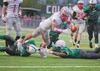 Wasilla senior Cash McGregor dives past Colony’s Logan Conway and Antonio Bush during a game against the Knights at Colony High School. McGregor was named first team all-state on both offense