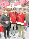 Hunter Altenberger, left, Elijah Barcelona, middle, and Elijah Kelley, right, sell 50-50 Split the Pot tickets at the Wasilla gun show last weekend. Kyle Wilkinson