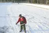 ROBERT DEBERRY/Frontiersman Wasilla resident Dennis Cooley puts
down water for the first layer of ice at the outdoor ice rink near
Iditarod Elementary Saturday afternoon. Cooley says it takes