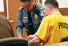A bailiff fingerprints Jeramie Sharp shortly after his sentencing Friday in the Palmer Court. Sharp had been charged with attempted first-degree murder for a series of incidents in Caswell in