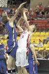 Wasilla guard Jared Straight reaches to stop a shot from
Wasilla’s Connor Devine during Friday’s game at the ASAA/First
National Bank 4A State Basketball Championship Tournament in
Anchorage.