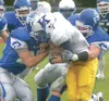 JEREMIAH BARTZ/Frontiersman Palmer senior defensive back Mitch
Swetzof, left, and senior linebacker J.D. Mitchell stop Kodiak
running back Gary Anthony for a loss during Palmer’s 14-0 win ove