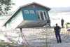 A house owned by Chris and Daina Mirsch-Wenner sinks into the Matanuska River. HEATHER A. RESZ/Frontiersman