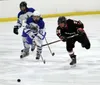 Houston senior Andrew Natekin flips the puck forward as Palmer's Jaron Ketterman tries to chase it down during Palmer's 4-1 win over Houston Monday at the MTA Events Center in Palmer. Courtes