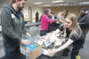 Jeff Toole and Bernadette Hartley help assemble kits containing naloxone, a drug that reverses opioid overdoses, at a Aug. 29, 2025 event in Anchorage. The volunteer event was organized by th