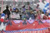 Fourth of July parader goers wave to the crowd during the City of Wasilla’s annual Fourth of July parade. Frontiersman file photo.